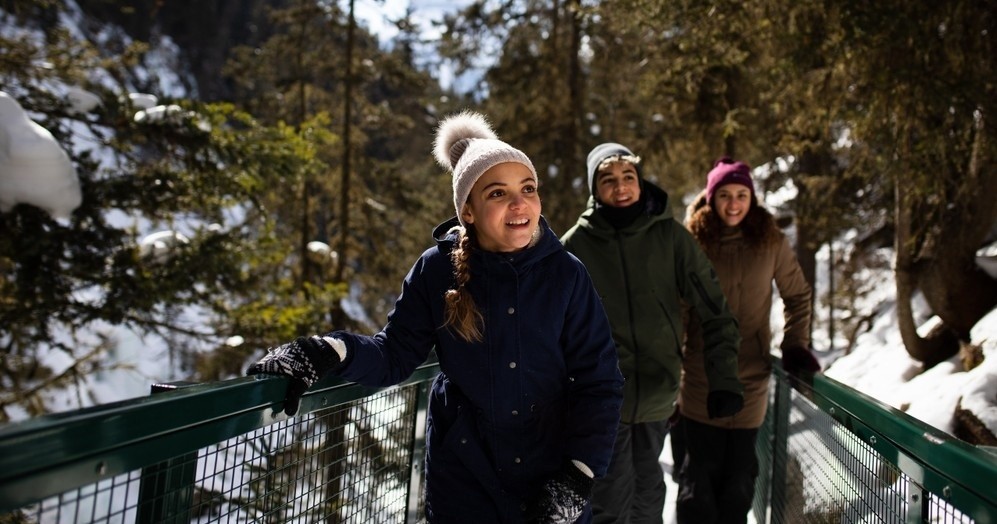 family on winter hiking trip to johnston canyon
