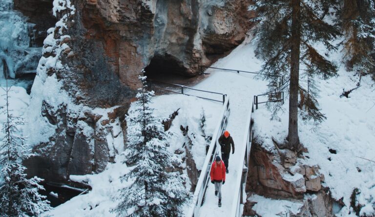 couple hiking through johnston canyon on tour