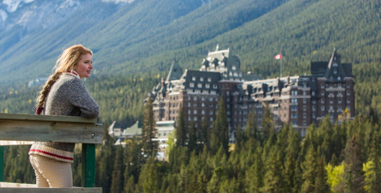 woman looking at banff hotel on guided tour