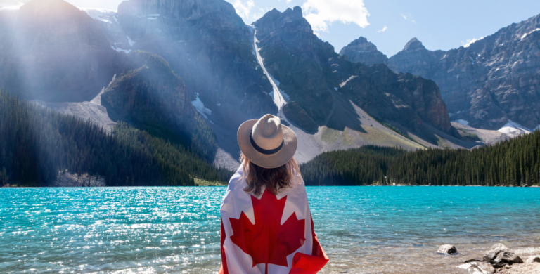 woman wearing canadian flag on tour of moraine lake