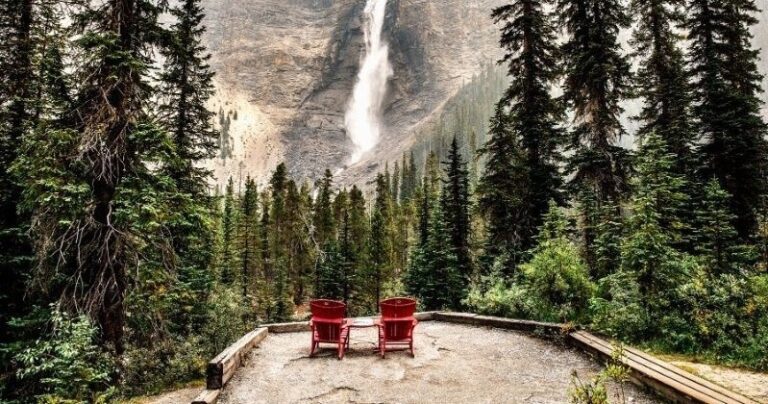 red chairs looking out at kootenay rockies