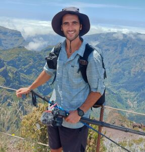 Banff tour guide, Lyubo, in hiking gear in front of mountain viewpoint in Banff