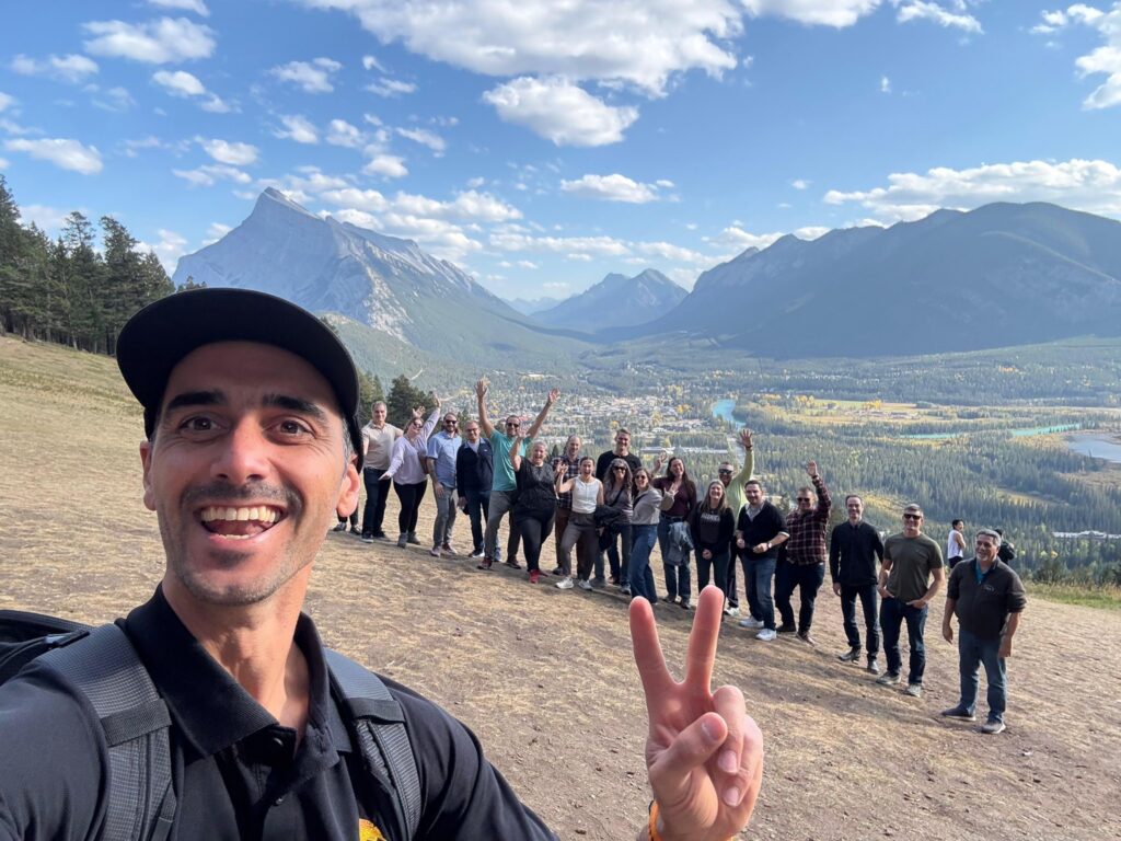Lyubo, a Banff tour guide overlooking Banff with a group of guests