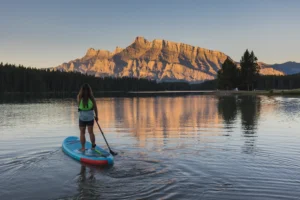 Woman on a paddle board on Two Jack Lake at sunset, Banff National Park
