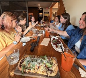 6 women sharing dinner at Grizzly Paw pub in Canmore, Alberta